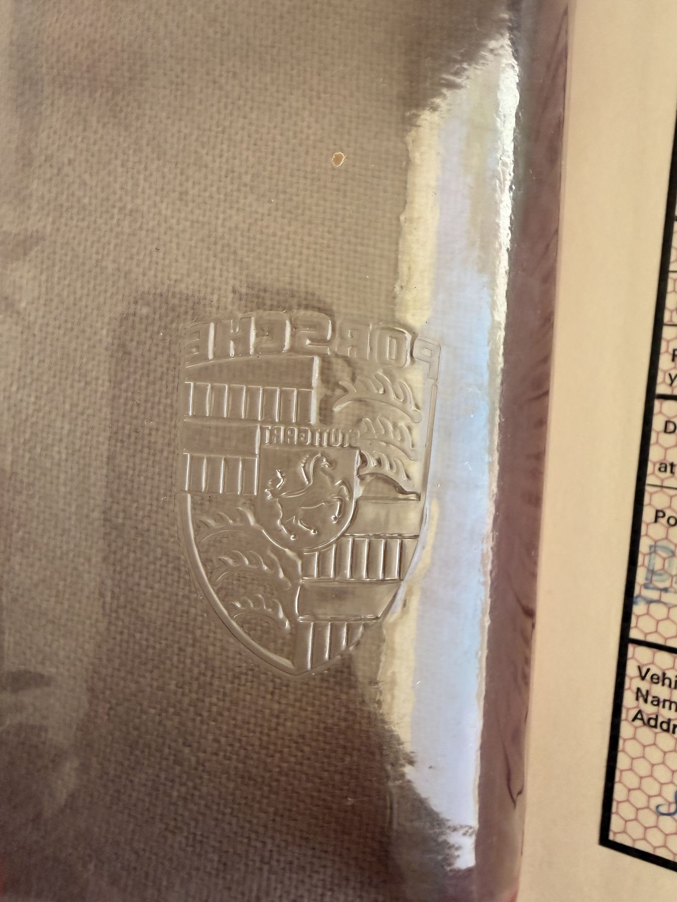 Porsche crest embossed on the record book cover